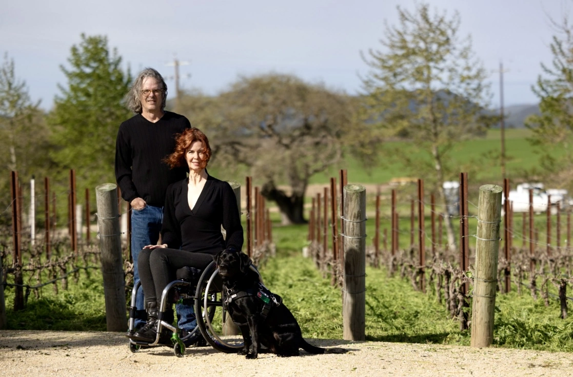 Wes and Chanda Hagen (with Kestrel the Service Dog) in a Santa Ynez Vineyard on a windy morning.